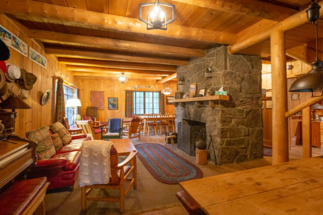 Family room with fireplace and multiple tables for gathering